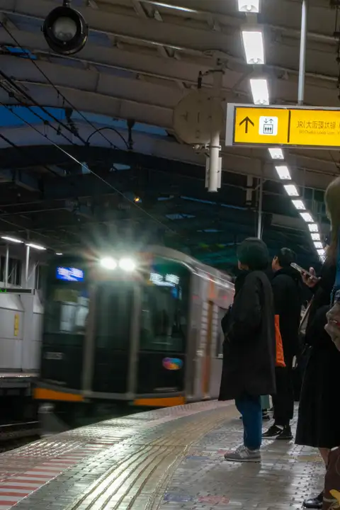 A commuter train arriving at a covered station platform